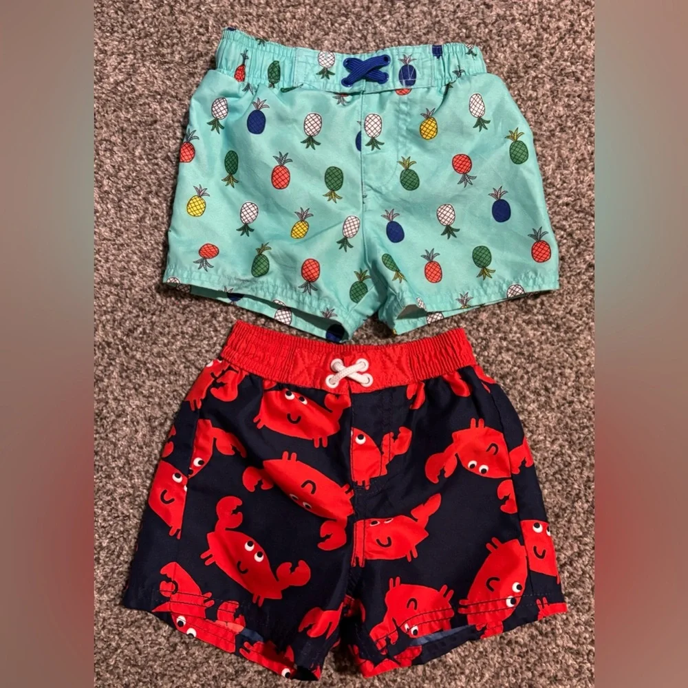 2 Pr. Boys Swim Trunks-Carter’s Crab Swim Trunks and Cat & Jack Pineappl…